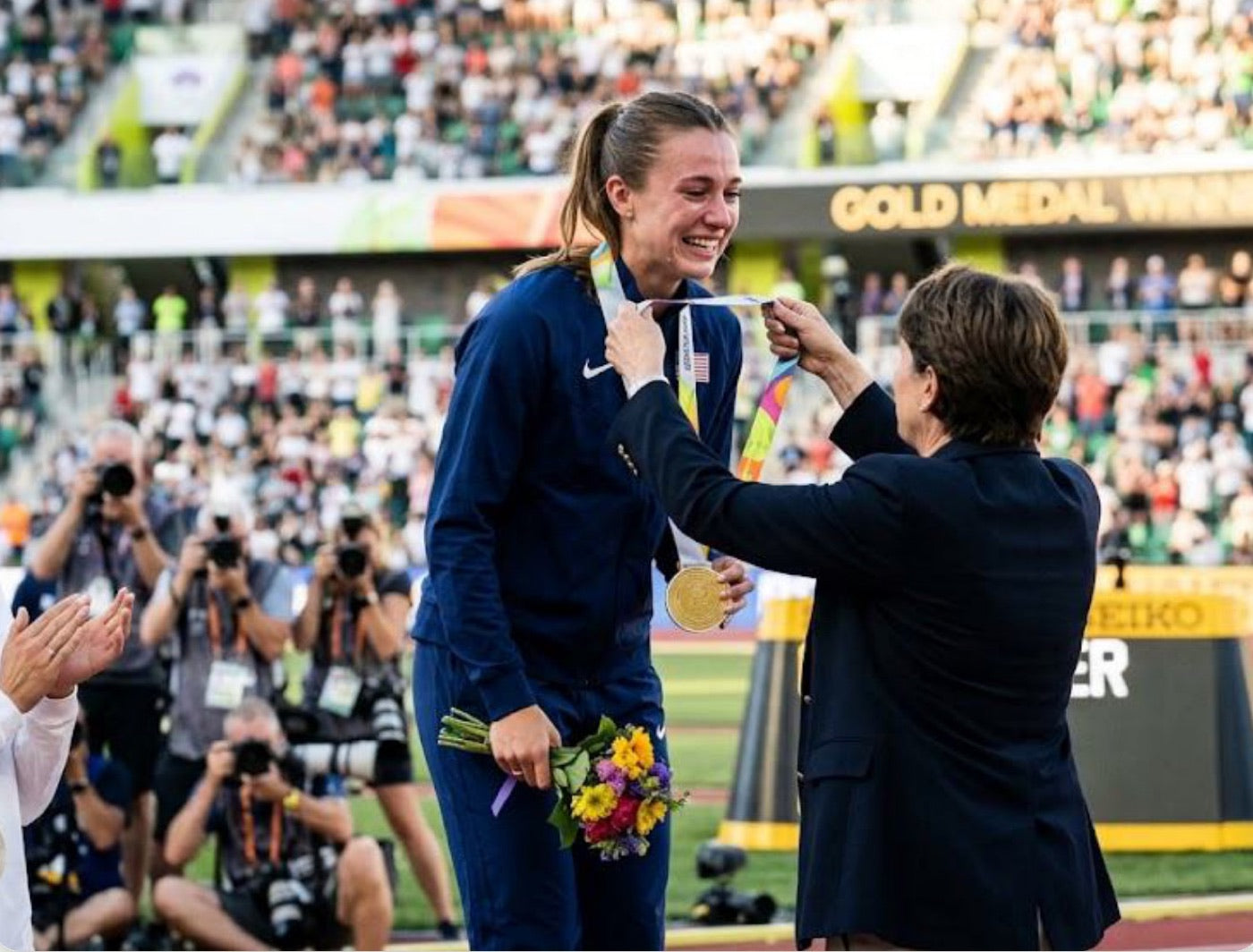 Athlete receiving a medal on the podium